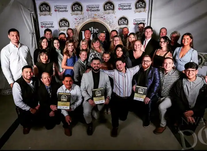 The Surfco team at the Best of Northwest Arkansas awards, holding their plaques